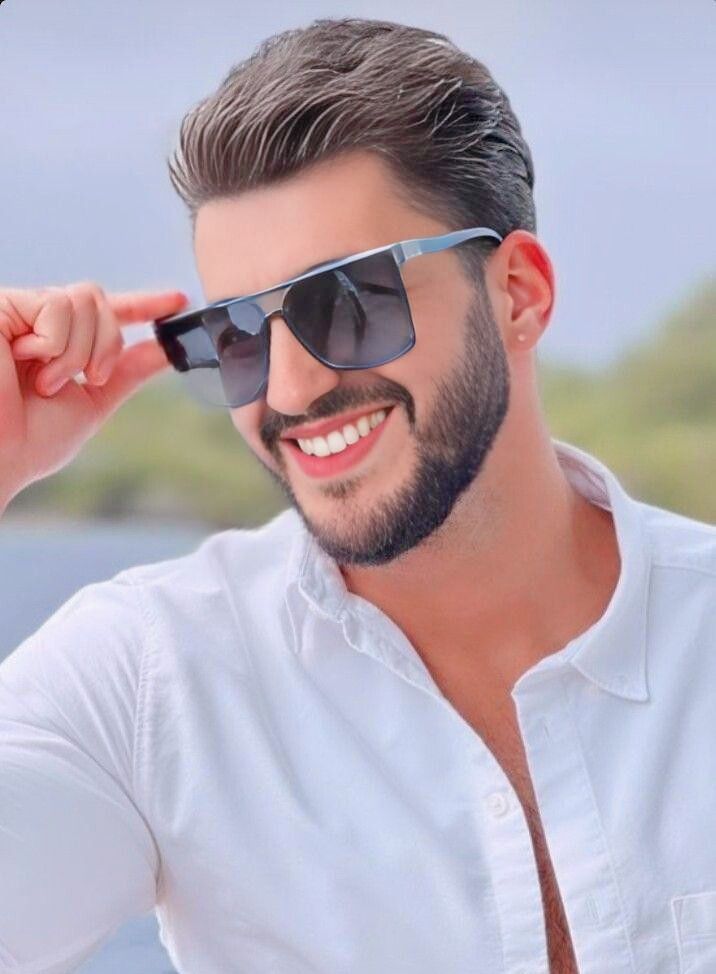 bărbat brunet, aranjat și stilat cu ochelari de soare și un zâmbet perfect, dinți albi și sănătoși.